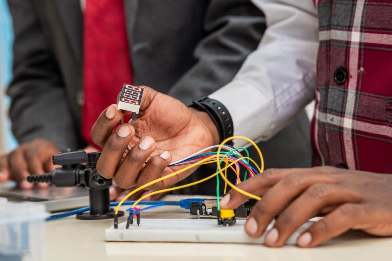 Precious Schools student testing a robotics circuit during a practical STEM activity