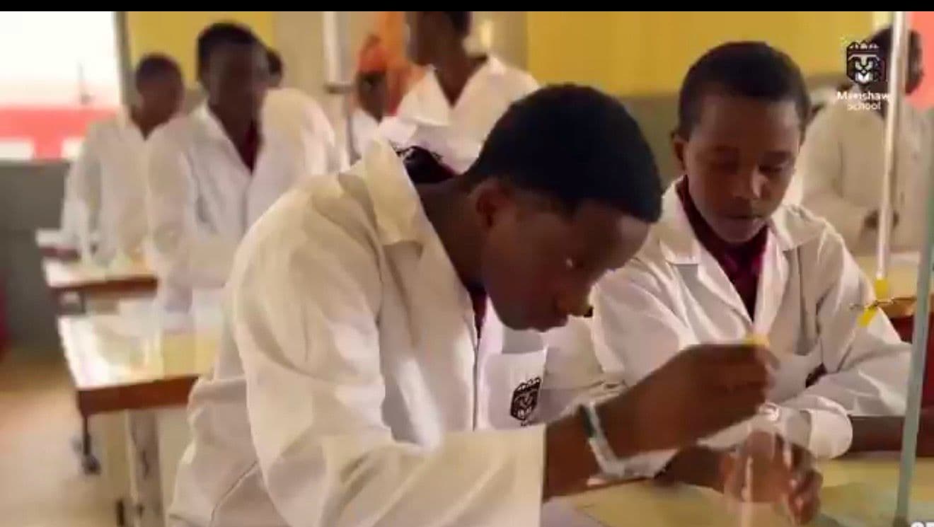 Precious Schools students conducting a practical experiment in the science laboratory