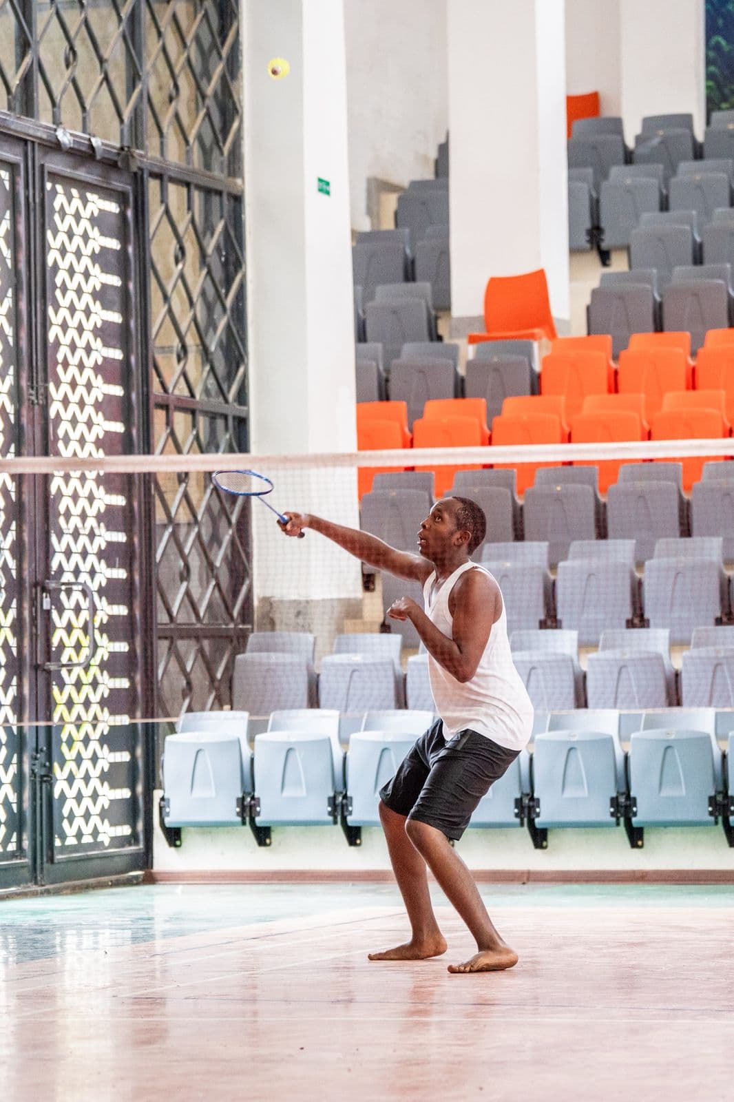 Precious Schools student playing badminton on the indoor court