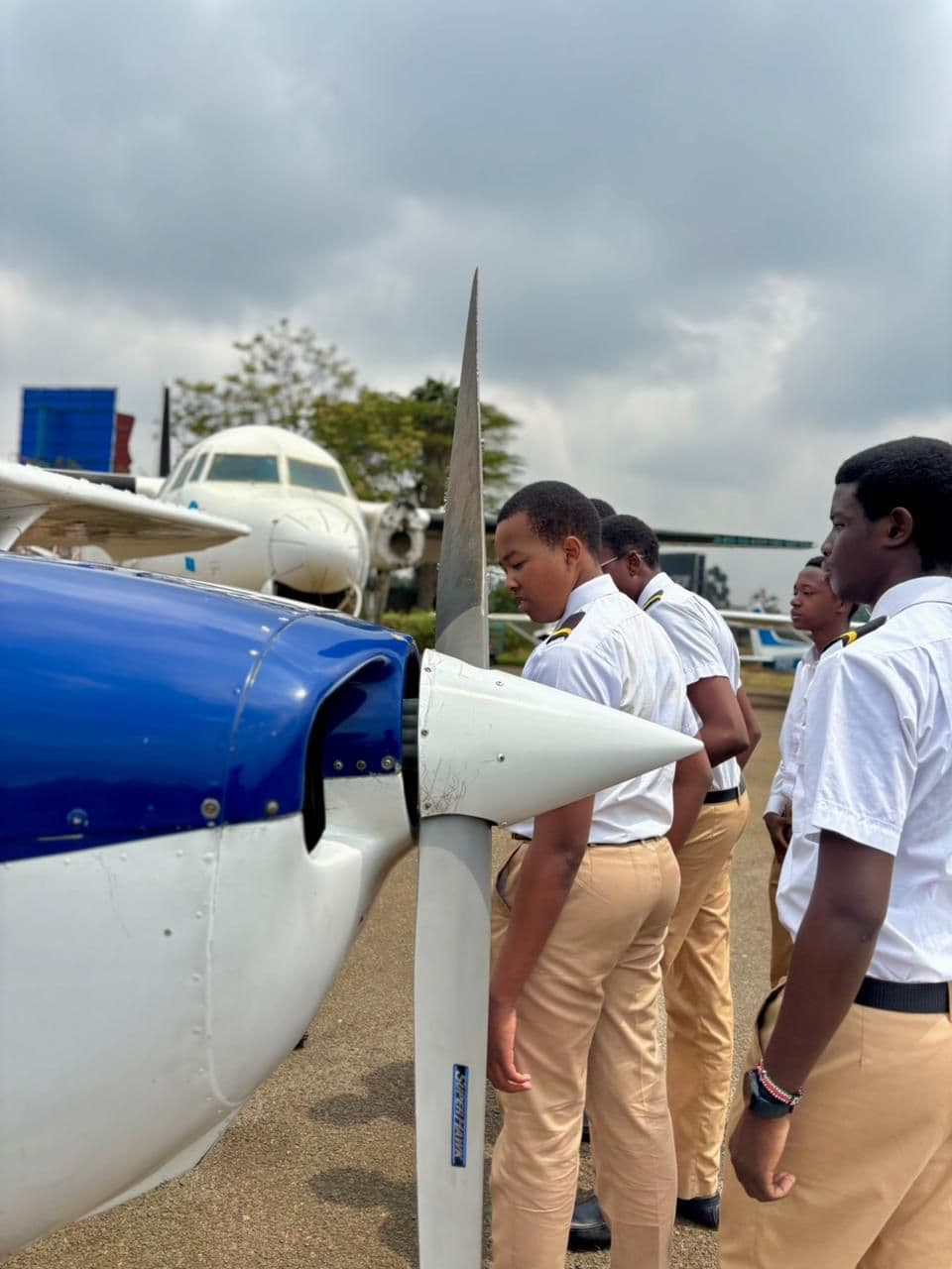 Precious Schools aviation students examining an aircraft propeller