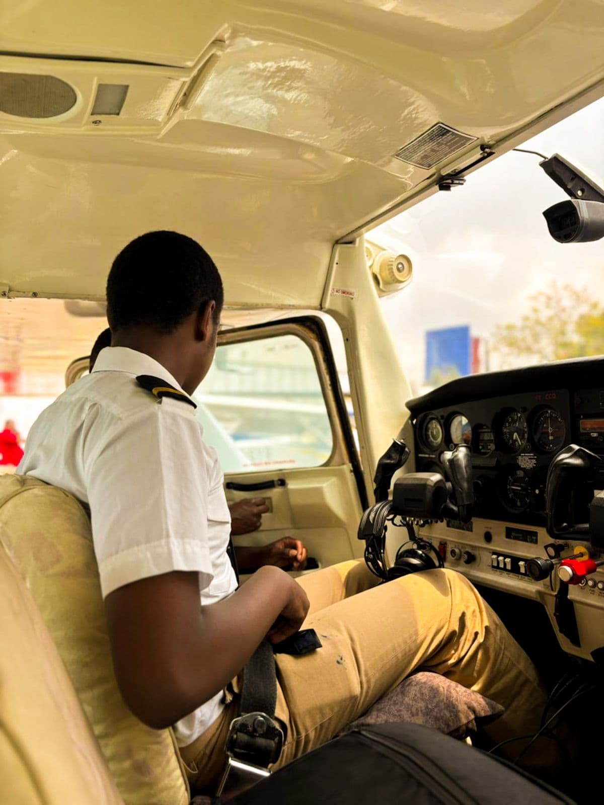 Precious Schools aviation student exploring an aircraft cockpit