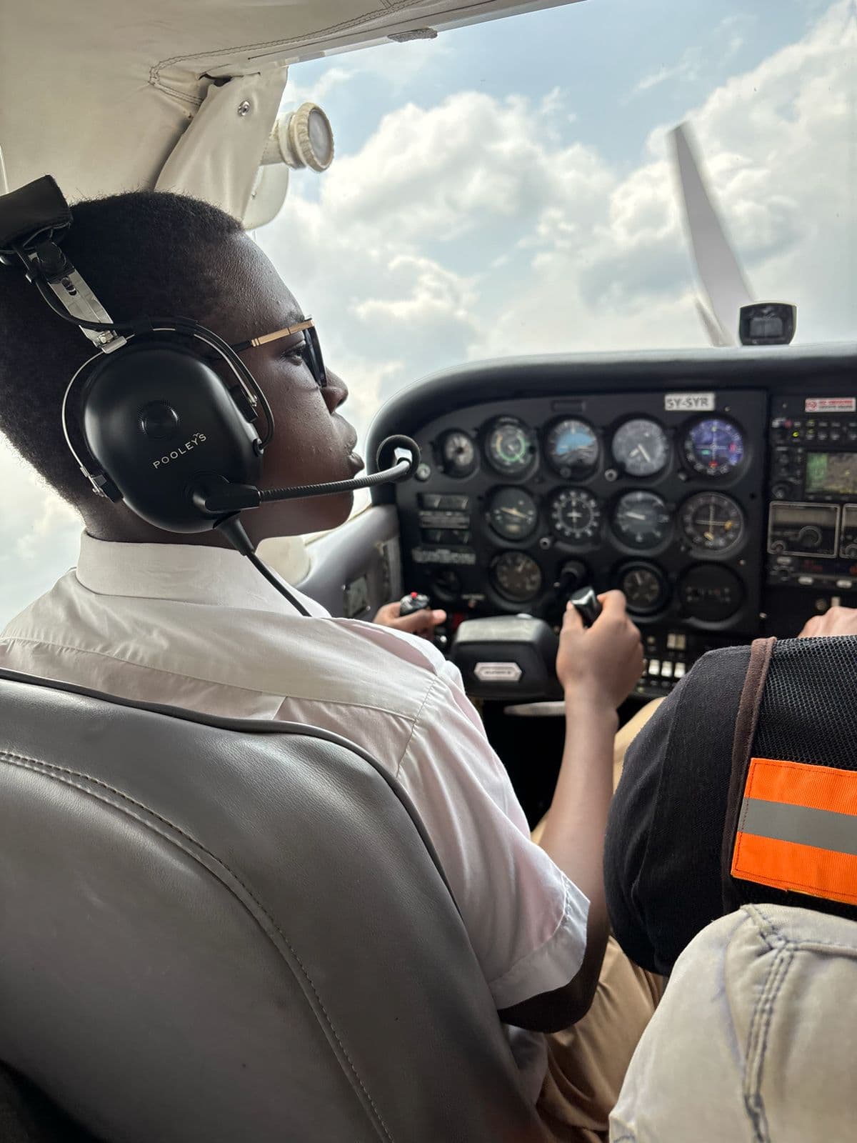 Precious Schools aviation student observing the cockpit instruments