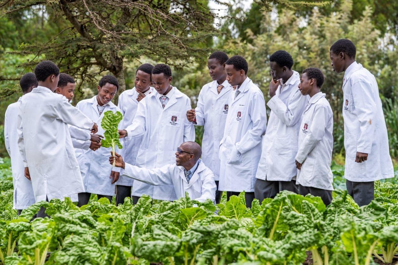 Precious Schools students learning practical agriculture skills in the school garden